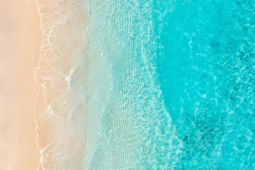 Fototapeten Summer seascape beautiful waves, blue sea water sunny day. Top drone view. Tranquil sea aerial amazing tropical nature Mediterranean. Beautiful bright sea waves splashing and beach sand sunset light © icemanphotos