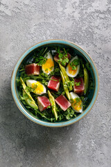 Salad with tuna grilled fillet, avocado and eggs. Top view. Copy Space