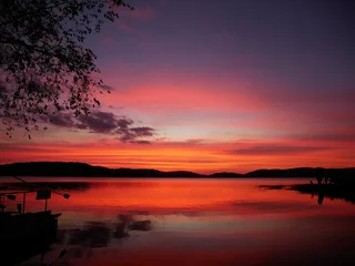Aluminium Prints purple Sunset in the evening at a reservoir behind a dam.
