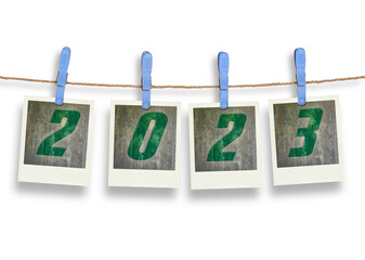 Four  plastic clothespins and instant frame with 2023 text for pictures