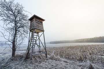 Fototapeta premium Frozen landscape in the countryside with hunting high seat.
