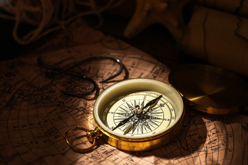 Fototapeta na wymiar Golden compass and hooks on world map