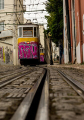 The graffiti covered yellow Funicular railway in Lisbon, Portugal