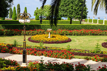 View of beautiful park with bright flowers and green trees on sunny day