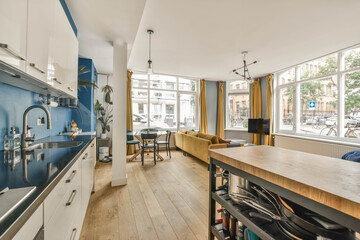 a kitchen and dining area in a house with blue walls, wood flooring and white cabinetd appliances...