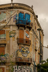 Fototapeta na wymiar Brightly colored graffiti on building exteriors in Lisbon, Portugal 
