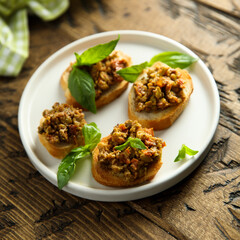Crostini with olive tapenade and basil