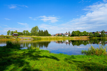 Fototapeta premium Nature at the Oberer Eschenbacher Teich near Clausthal-Zellerfeld. Landscape at the lake in the Harz Mountains with the surrounding green nature. 