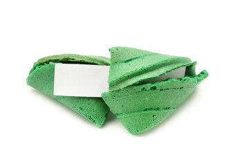 Green fortune cookies with piece of paper on white background