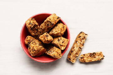 Ceramic bowl with tasty biscotti cookies on white background