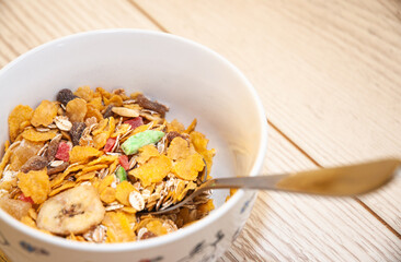 Healthy breakfast - cornflakes in a bowl on the table.