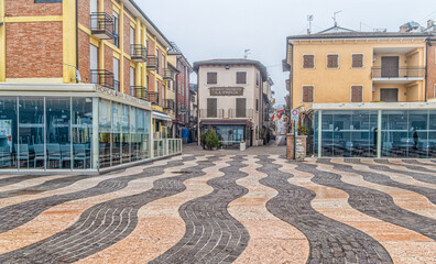 Historic centre of the picturesque town of Lazise on Lake Garda in the winter season. Lazise, Verona province, northern Italy - January 21, 2022