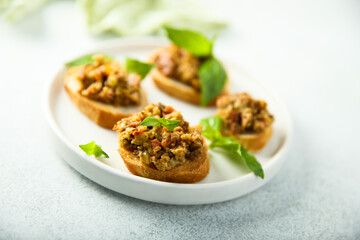 Crostini with olive tapenade and basil