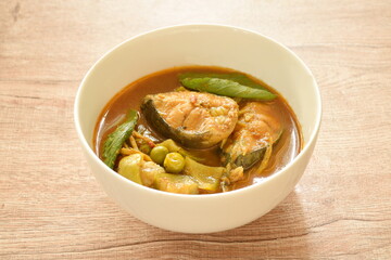 spicy boiled slice catfish with eggplant in coconut milk and curry on bowl
