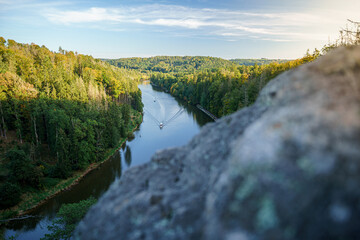 Slow river in rocks at sunny autumn landscape