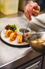 man chef cooking fried shrimp on kitchen