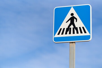 pedestrian crossing traffic sign over blue sky