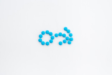 Male sign made of blue pills. Impotence concept