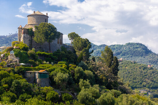 Brown Castle surrounded by green olive trees and plants in the middle of the summer. Castello Brown is a historic house museum located high above the harbour of Portofino, Italy.