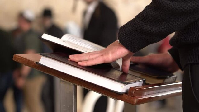 Close-up shot of a man praying at the Western Wall (Kotel) in Jerusalem, Israel
