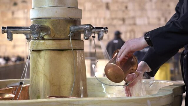 Ritual of hand washing at the Western Wall located in the old city Jerusalem