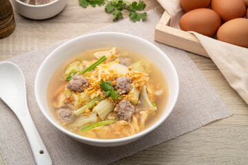 Clear soup with fried egg and minced pork ,Chinese Cabbage in white bowl