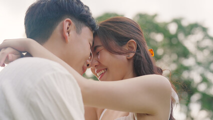 Young adult asia people fiance happy lover flirt fall in love nose kiss hug cuddle care trust. Sweet comfort touch newlywed asian couple life man smile look at woman face relax warm time dating day.
