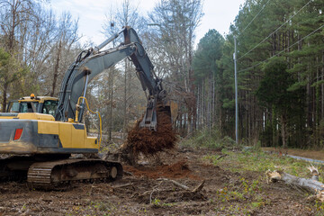 Tractor backhoe was used to remove stump roots from trees that were cut down make way for...