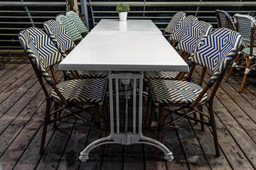 table and chairs in a street restaurant at night