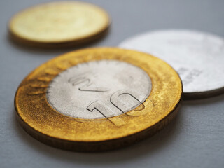 Indian money lies on gray surface. 10 ten rupee coin closeup. News about economy or finances of India. Reserve bank rate and public debt. National currency or finance. Macro