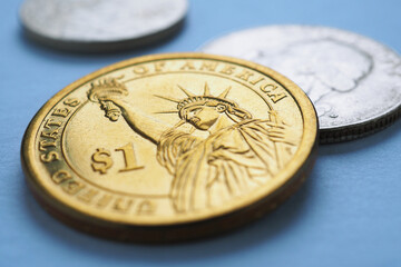 American coin lies on blue surface. One dollar coin closeup. Statue of Liberty. Sign of national currency. USA economy and money. News about inflation and Fed rate. US public debt and treasury. Macro
