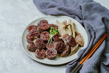 Sundae, Korean Blood Sausage : Pork intestines stuffed with glass noodles, vegetables, sweet rice, coagulated pig's blood (seonji) and steamed. Variations include Ojingeosundae (stuffed squid) and cha