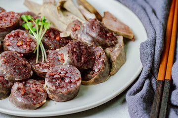 Sundae, Korean Blood Sausage : Pork intestines stuffed with glass noodles, vegetables, sweet rice, coagulated pig's blood (seonji) and steamed. Variations include Ojingeosundae (stuffed squid) and cha