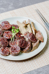 Sundae, Korean Blood Sausage : Pork intestines stuffed with glass noodles, vegetables, sweet rice, coagulated pig's blood (seonji) and steamed. Variations include Ojingeosundae (stuffed squid) and cha