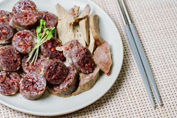 Sundae, Korean Blood Sausage : Pork intestines stuffed with glass noodles, vegetables, sweet rice, coagulated pig's blood (seonji) and steamed. Variations include Ojingeosundae (stuffed squid) and cha