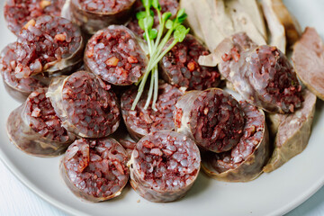 Sundae, Korean Blood Sausage : Pork intestines stuffed with glass noodles, vegetables, sweet rice, coagulated pig's blood (seonji) and steamed. Variations include Ojingeosundae (stuffed squid) and cha