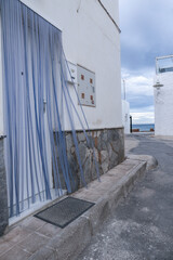 Whitewashed facade and narrow street in Andalusia