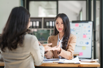 Asian company employees and colleagues work together in the office. by talking and giving advice to each other