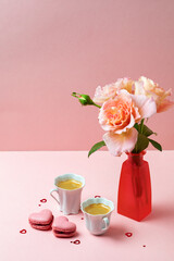 Romantic setup with coffee, macarons and roses - 557897833