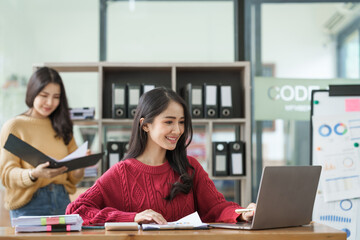 Asian company employees and colleagues work together in the office. by talking and giving advice to each other