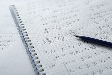 Notebook with different mathematical formulas and pen, closeup