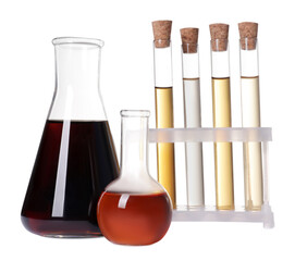 Different laboratory glassware with brown liquids on white background