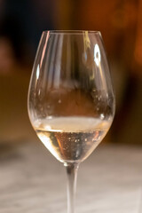 A glass of wine on the table, with blur background in the restaurant