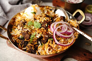 Homemade Goat Fry biryani | Mutton dum biryani served with yogurt raita, selective focus