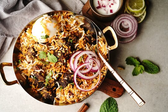 Homemade Goat Fry biryani | Mutton dum biryani served with yogurt raita, selective focus