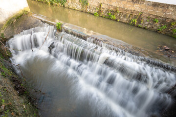 Long exposure of a waterfall on the River Lim walkway in Lyme Regis