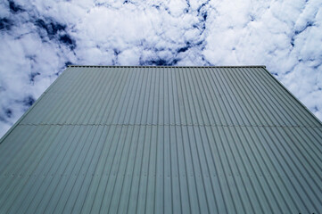 Fototapeta na wymiar Dark blue sky and building facade in Belo Horizonte. A cloud. Space for advertisement.