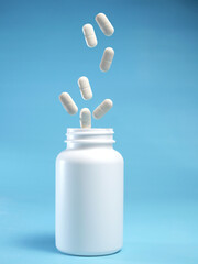 pain killer levitate and the bottle isolated on blue background