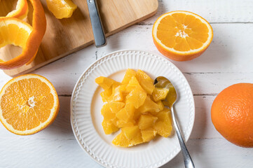Chopped oranges on a white plate for healthy snack or dessert