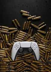 Modern game joystick on the background of empty cartridge cases. Esports poster concept. Shooter...